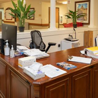 A well-organized office desk with office supplies, plants, and technology.
