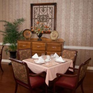 A cozy dining area with a neatly set table and elegant decor.