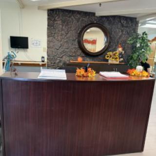 A warm and welcoming reception area featuring a decorative wall and seasonal accents.