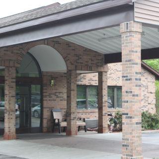 A brick building entrance with a covered canopy.