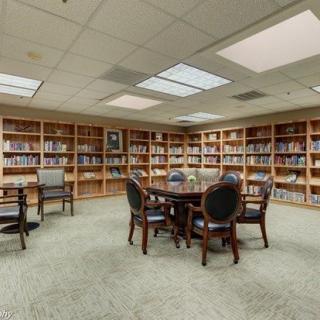 A quiet library reading room with bookshelves and seating area.