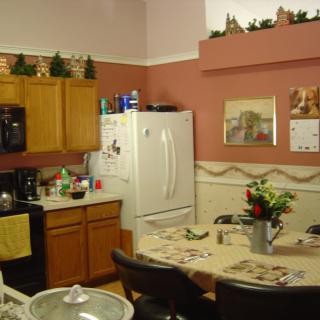 Cozy kitchen and dining area with decorative elements and a table set for meals.