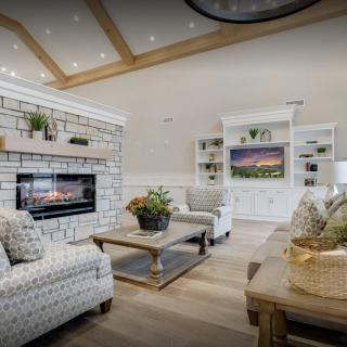 A cozy and stylish living room featuring a fireplace, comfortable seating, and modern decor.