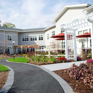 A well-maintained residential building with a landscaped garden and pathway.