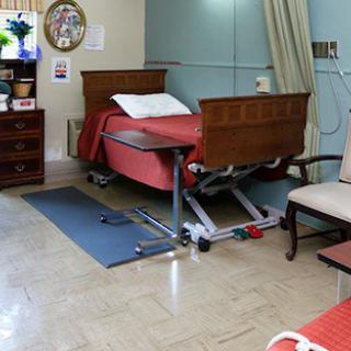 A hospital room with a bed and medical equipment.