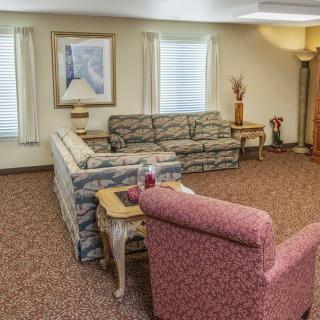 A cozy living room with patterned furniture and decorative elements.