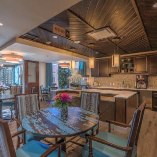A modern kitchen and dining area with wooden furniture and an open layout, creating a cozy atmosphere.
