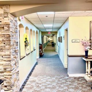 A brightly lit hallway with stone accents and decorative elements.
