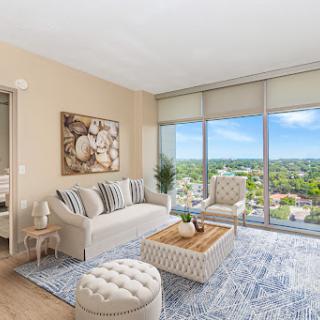 A bright and modern living room with a stunning view, featuring contemporary furniture and a cozy ambiance.