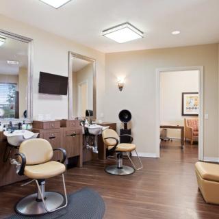 A modern hair salon with stylish chairs and professional equipment in a clean, well-lit setting.