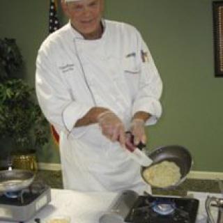 A chef skillfully preparing a dish in the kitchen.