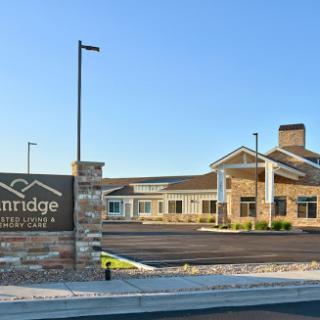 Exterior view of a senior living facility with clear signage.