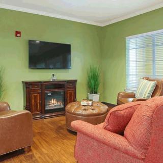 Cozy living room with comfortable seating, a fireplace, and a wall-mounted TV.