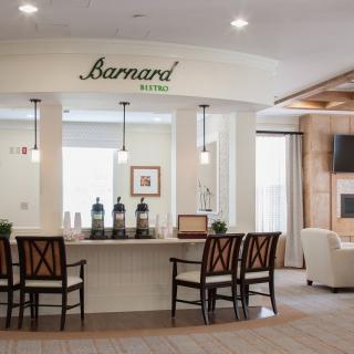 Modern cafe interior with a sleek counter and comfortable seating.