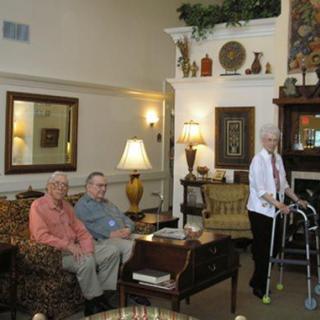 Elderly individuals relaxing in a cozy living room setting.