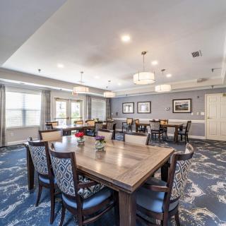 A modern dining room with elegant furnishings and ambient lighting.