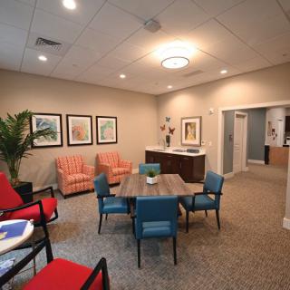 A modern lounge area with comfortable seating and artwork on the walls.