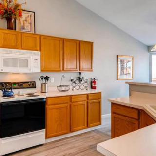 Modern kitchen with wooden cabinets and appliances.