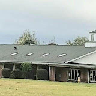 A view of a building with skylights under a cloudy sky.
