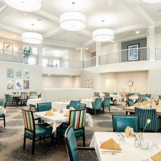 Elegant dining area with stylish furniture and lighting.