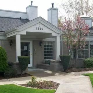 A charming residential building with a welcoming entrance and well-maintained landscaping.