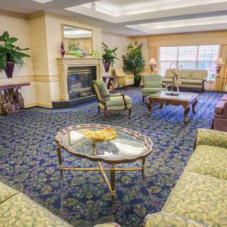A spacious hotel lobby with elegant furniture and large windows.