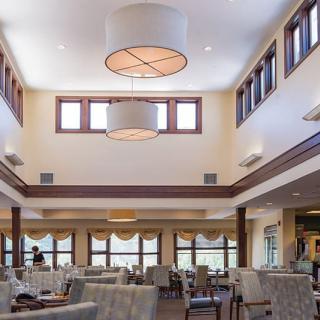Spacious dining area with modern lighting and ample seating.