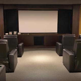 A cozy home theater setup with comfortable seating and a large screen.