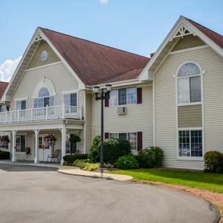 A traditional two-story house with a symmetrical facade and well-maintained landscaping.