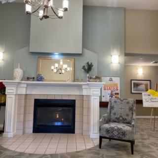 A cozy room with a fireplace, chandelier, and elegant decor.