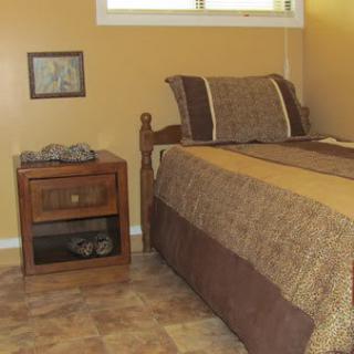 A cozy bedroom with a single bed and nightstand beside it.