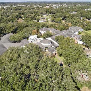 Aerial view of a suburban area surrounded by lush green trees.