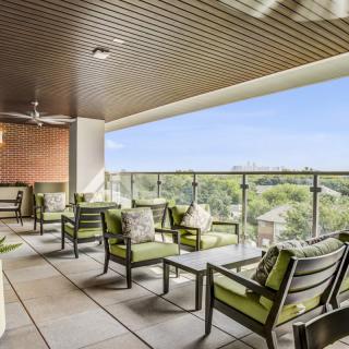 A modern balcony with comfortable seating and a scenic view.