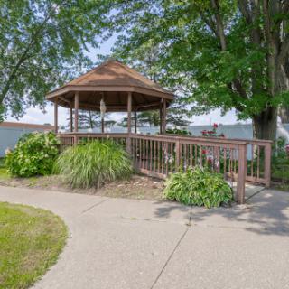 A charming gazebo surrounded by greenery, offering a peaceful spot to relax in nature.