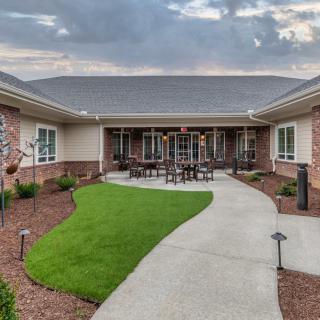 A well-maintained courtyard with a central pathway and surrounding building.
