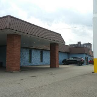 An exterior view of a commercial building with a parking area.