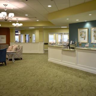 A well-lit lobby with a reception desk and comfortable seating.