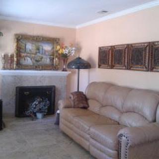 A cozy living room with a sofa, fireplace, and decorative elements.