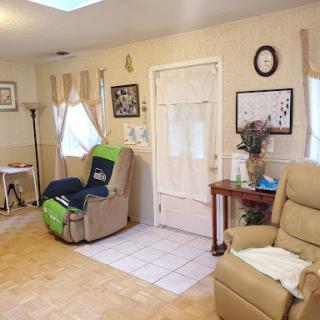 A cozy living room featuring comfortable seating, decorative elements, and natural light.