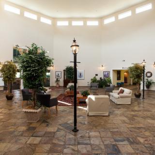 A spacious lobby area with comfortable seating and decorative plants.