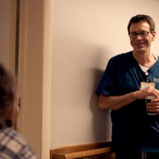 A healthcare professional engages with a patient in a warm and friendly manner.