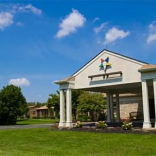 A building entrance with columns under a clear blue sky.