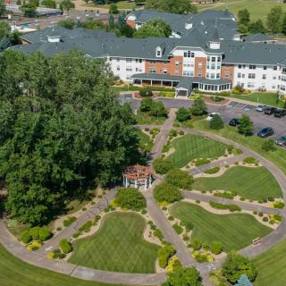 Aerial view of a building surrounded by landscaped gardens and pathways.