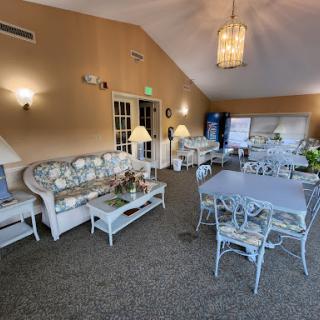 A cozy lounge area featuring comfortable sofas and elegant tables, perfect for relaxation and gatherings.