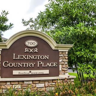 Entrance sign for Lexington Country Place surrounded by trees.