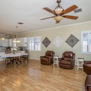 Spacious open-concept living room and kitchen with hardwood floors and comfortable seating.