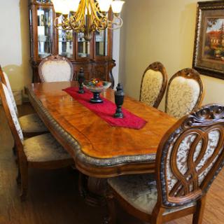 A beautifully arranged dining room with a classic wooden dining table and elegant chairs.