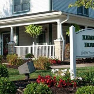 A charming house with a welcoming front porch and vibrant landscaping.
