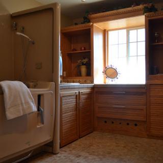 A beautifully designed bathroom featuring wooden cabinetry and a spacious layout.