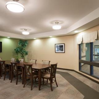 A cozy dining area featuring a wooden table, chairs, and natural lighting.